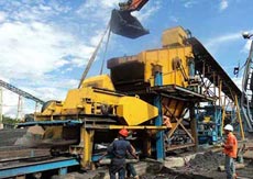 How does oil filter crusher adjust the ejection of material?
